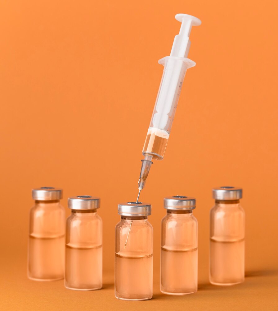 Coronavirus vaccine assortment on orange