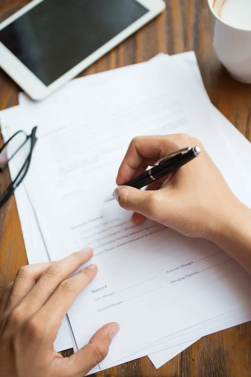 Unrecognizable man filling application form