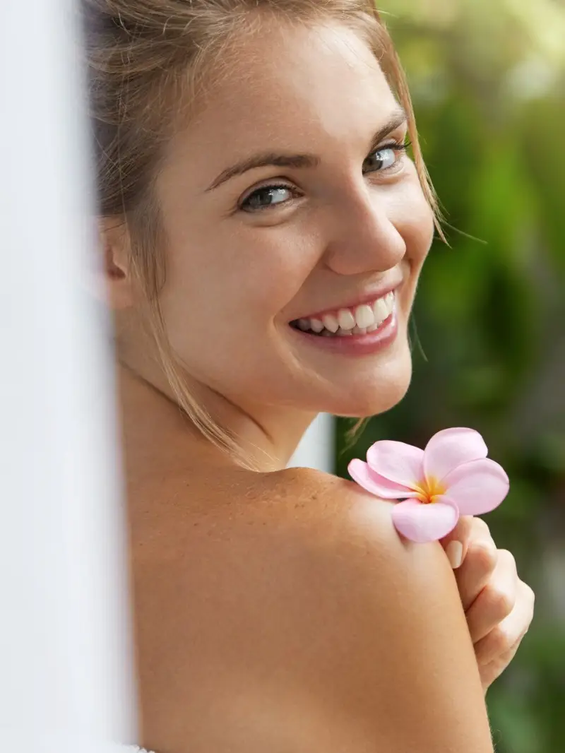 Smiling young woman in towel